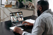 © Kateryna - African american man talking with colleagues by video call uses laptop and app, takes notes, discuss ideas. Group brainstorm, online video meeting, virtual conference with multiracial colleagues