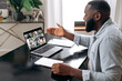 © Kateryna - Positive african american man communicates with colleagues by video call uses laptop and app, takes notes, discuss ideas. Group brainstorm, online video meeting, virtual video conference