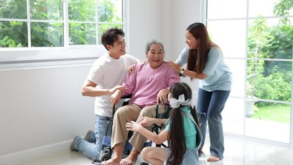 Wall Mural - Happy asian family father, mother and daughter take good care of grandmother, They are smiling and laughing together at new house on moving day.