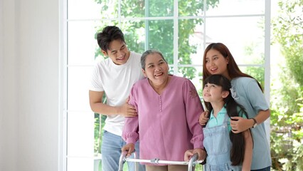 Wall Mural - Happy asian family feel excitement moving to new house, Grandmother using walker , father, mother and daughter support beside her on moving day.