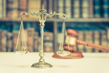 Legal Office Of Lawyers Or Attorneys, Justice And Law Concept : Brass Balance Scale Of Justice On A Courtroom Desk With A Judge Gavel Behind, Representing The Delicate Balance Of Truth And Fairness.
