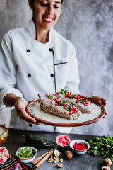 Wall Mural - mexican woman chef cooking chiles en nogada recipe with Poblano chili and ingredients, traditional dish in Puebla Mexico	