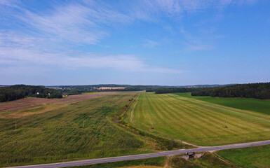 Wall Mural - Aerial view of agro rural fields. Harvesting on the farm landscape