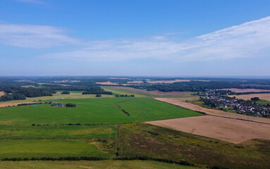 Wall Mural - Aerial view of agro rural fields. Harvesting on the farm landscape