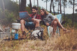 © Jacob Lund - Young couple looking at a map while sitting at their campsite