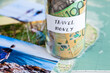 © Austockphoto - Travel in Australia to coastal destination concept - money in jar on map with holiday photos
