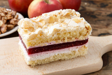 Wall Mural - Layer fruit cake with meringue topping and raspberry sauce.