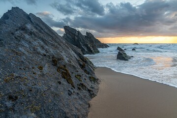 Wall Mural - Adraga beach at beautiful sunset at low tide in Sintra, Portugal