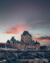 Vertical Breathtaking View Of Old Castle On Pink Sunset Sky Background In Quebec City