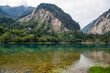 Panorama of the two green mountains reflecting from the mirror surface of the emerald turquoise Five Color Pond lake in Jiuzhaigou, Aba Tibetan Autonomous Prefecture, Sichuan, China