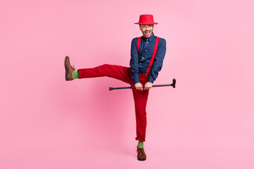 Sticker - Full size photo of overjoyed cheerful man hands hold stick stand one leg dancing isolated on pink color background