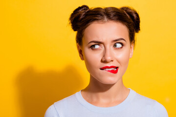 Wall Mural - photo of curious female bite her lips look blank space brainstorming isolated on yellow color backgr