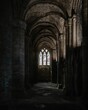 © Joshua P Jacks/Wirestock Creators - Interior of an ancient stone cathedral with pillars, arches, and large windows in Scotland, UK