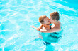 © AndriiKoval - Romantic couple kissing in a blue swimming pool. Enjoying. Gentle. Passion. Paradise. Perfect. Together. Swim. Relax. Recreation. Relaxation. Wet. Idyllic. Villa. Lagoon. Bonding. Young