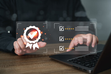 Sign of the top service quality assurance concept,Businessman Hand shows the sign of the top service Quality assurance on virtual screen and use laptop mark check rating to the service experience