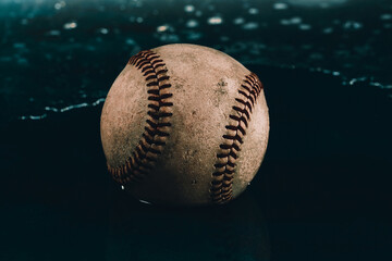 Canvas Print - Retro baseball used in game with water background for rain delay or game concept.
