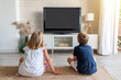 © Fran Rodríguez - Two children sitting on the living room floor watching television. Mock up for inserting images in the tv