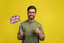 Happy Man Holding Flag Of UK And Showing Thumb Up, Recommending Online Educational Course