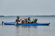 © Ekaterina - Going kayak boating with dogs on river, active pets concept, happy dog and owner on adventure. Young couple with dreadlocks having fun on vacation with German and Australian Shepherd dogs.
