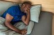 © Prostock-studio - African American Male Suffering From Insomnia Lying In Bed Indoors