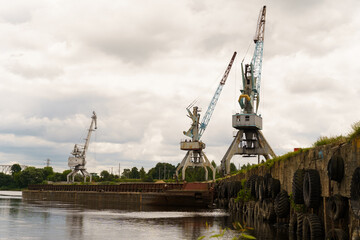 Wall Mural - Cranes in the port at the loading of water transport.