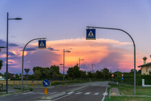 Sunset Over The Road And Crosswalk, Street Lighting Electric Poles Along The Road On The Outskirts Of The City In Italy, Crosswalk Signs Sky At Sunset, Sunset Sky Background Image