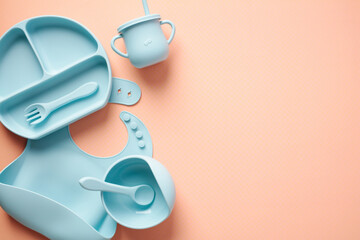 Silicone baby feeding set on color background. Flat lay, top view.