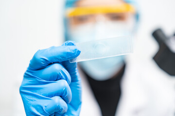 Wall Mural - professional research scientist using microscope in science chemistry laboratory, medical technology