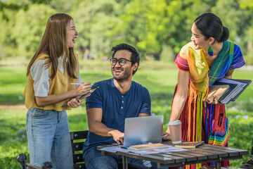 diversity of businessperson coworkers working and brainstorming together in pupblic park