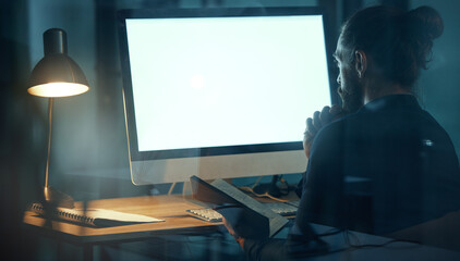Business man doing web design on computer at work, designer planning website online and working on advertising strategy in a dark office at night. Programmer doing overtime and programming on screen