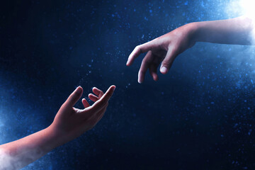 hands reaching on dark background