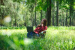 © Farknot Architect - A beautiful asian woman working and typing on laptop keyboard while sitting on a chair in the park