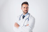 Fototapeta Na sufit - Careworn male doctor portrait while standing at isolated white background