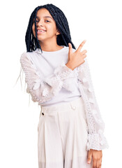 Poster - Cute african american girl wearing casual white tshirt cheerful with a smile of face pointing with hand and finger up to the side with happy and natural expression on face