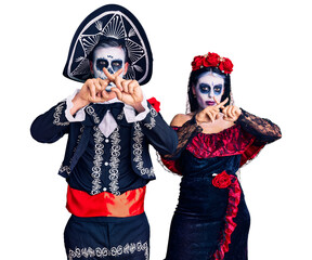 Sticker - Young couple wearing mexican day of the dead costume over background rejection expression crossing fingers doing negative sign