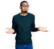 © Krakenimages.com - Young african american man wearing casual clothes and glasses clueless and confused expression with arms and hands raised. doubt concept.