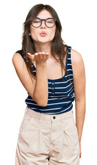 Canvas Print - Young beautiful caucasian girl wearing casual clothes and glasses looking at the camera blowing a kiss with hand on air being lovely and sexy. love expression.