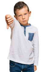 Sticker - Adorable caucasian kid wearing casual clothes looking unhappy and angry showing rejection and negative with thumbs down gesture. bad expression.