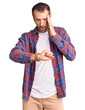 © Krakenimages.com - Young handsome man wearing casual clothes looking at the watch time worried, afraid of getting late