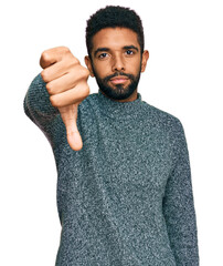 Canvas Print - Young african american man wearing casual clothes looking unhappy and angry showing rejection and negative with thumbs down gesture. bad expression.