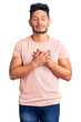 © Krakenimages.com - Handsome latin american young man wearing casual clothes smiling with hands on chest with closed eyes and grateful gesture on face. health concept.