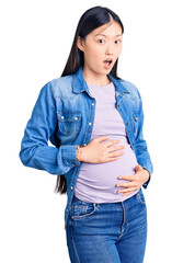 Sticker - Young beautiful chinese woman pregnant expecting baby afraid and shocked with surprise and amazed expression, fear and excited face.