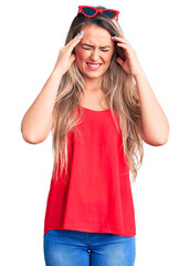 Poster - Young beautiful blonde woman wearing sleeveless t-shirt and sunglasses with hand on head for pain in head because stress. suffering migraine.