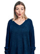 © Krakenimages.com - Young blonde woman wearing casual sweater afraid and shocked with surprise expression, fear and excited face.