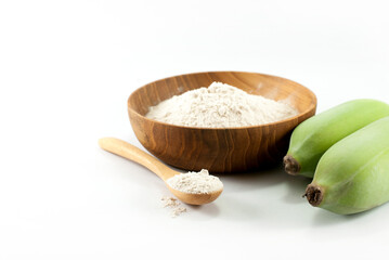 Banana flour and fresh green bananas on a white background, prebiotic food for gut health.