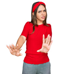 Wall Mural - Young brunette woman wearing casual clothes doing stop gesture with hands palms, angry and frustration expression