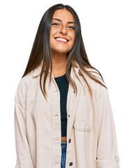 Wall Mural - Beautiful hispanic woman wearing casual clothes looking positive and happy standing and smiling with a confident smile showing teeth