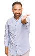 © Krakenimages.com - Handsome middle age man wearing business shirt smiling friendly offering handshake as greeting and welcoming. successful business.