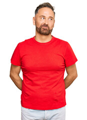 Sticker - Handsome middle age man wearing casual red tshirt smiling looking to the side and staring away thinking.