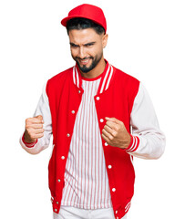 Poster - Young man with beard wearing baseball uniform excited for success with arms raised and eyes closed celebrating victory smiling. winner concept.